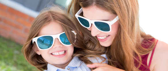 Mother and daughter in sunglasses laughing