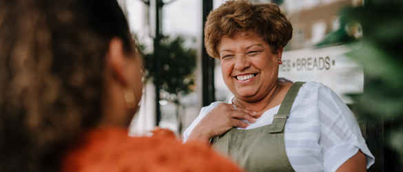 woman smiling outside bakery 