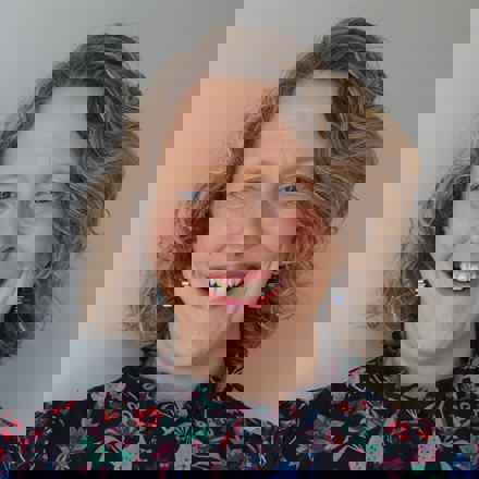 Close up portrait of Professor Ruth Hogg, smiling.