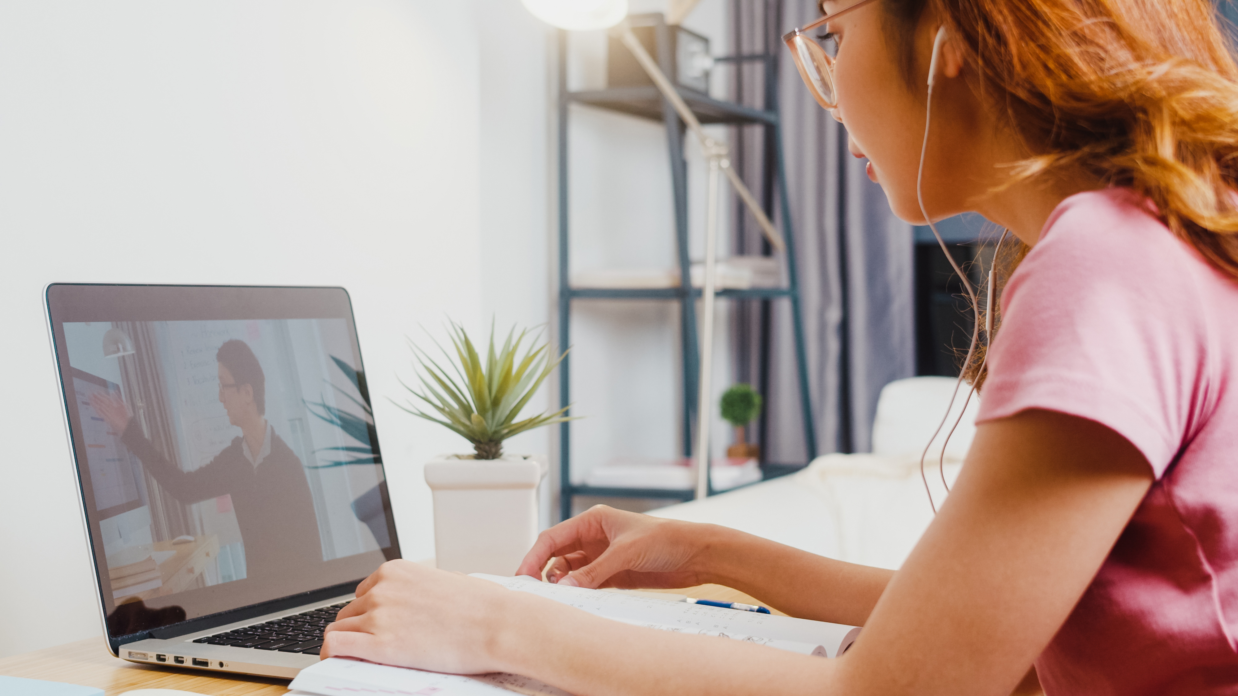 Young woman with headphones watching a video on a laptop