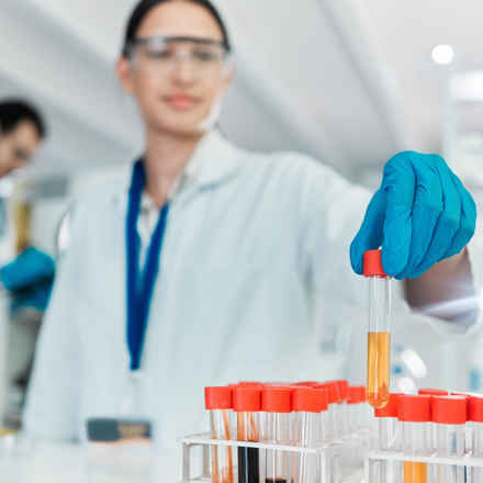 Researcher In Laboratory Holding Test Tubes