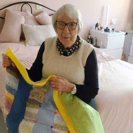 Audrey Drage holding quilt 