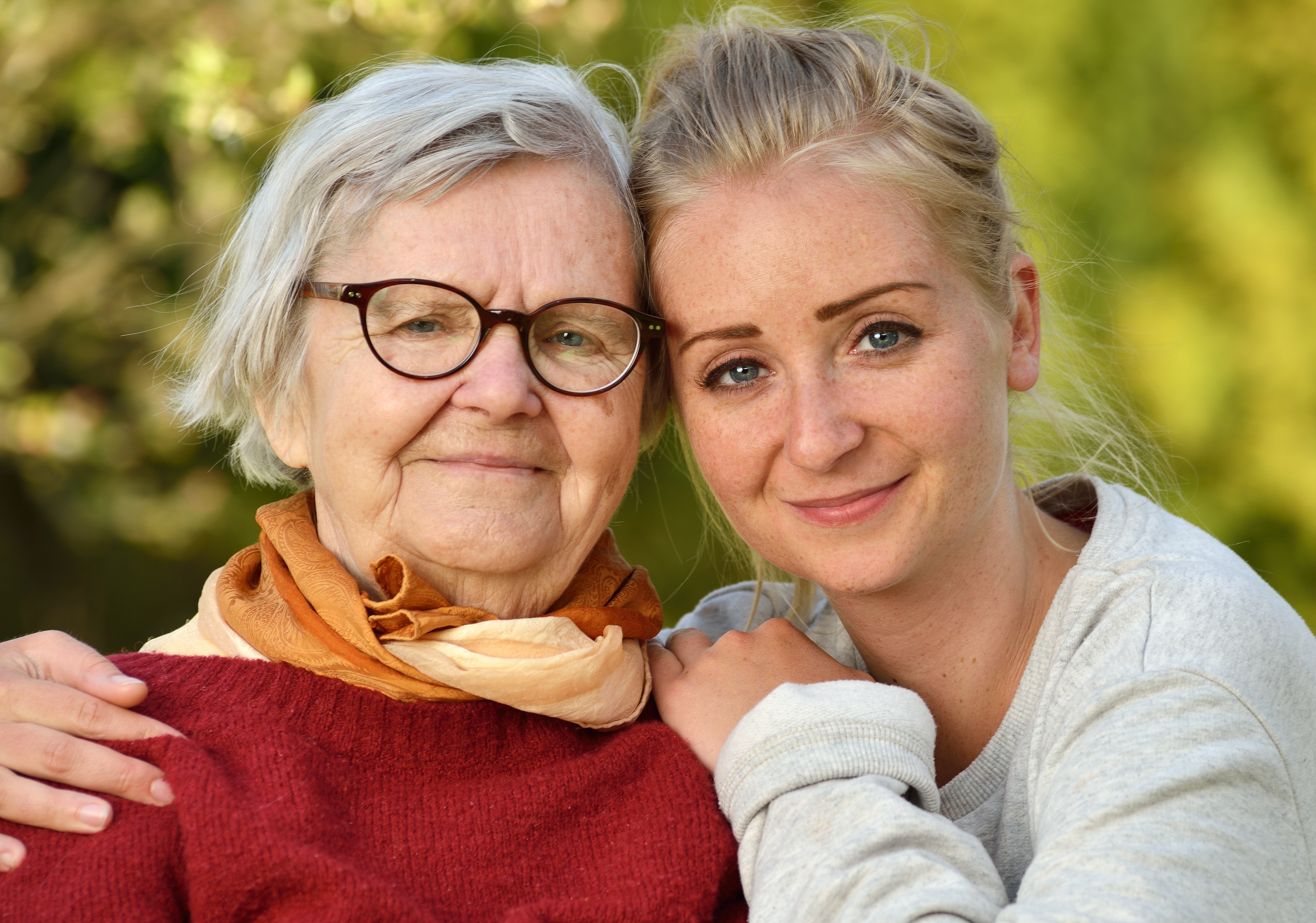 Granddaughter and grandmother hugging and smiling