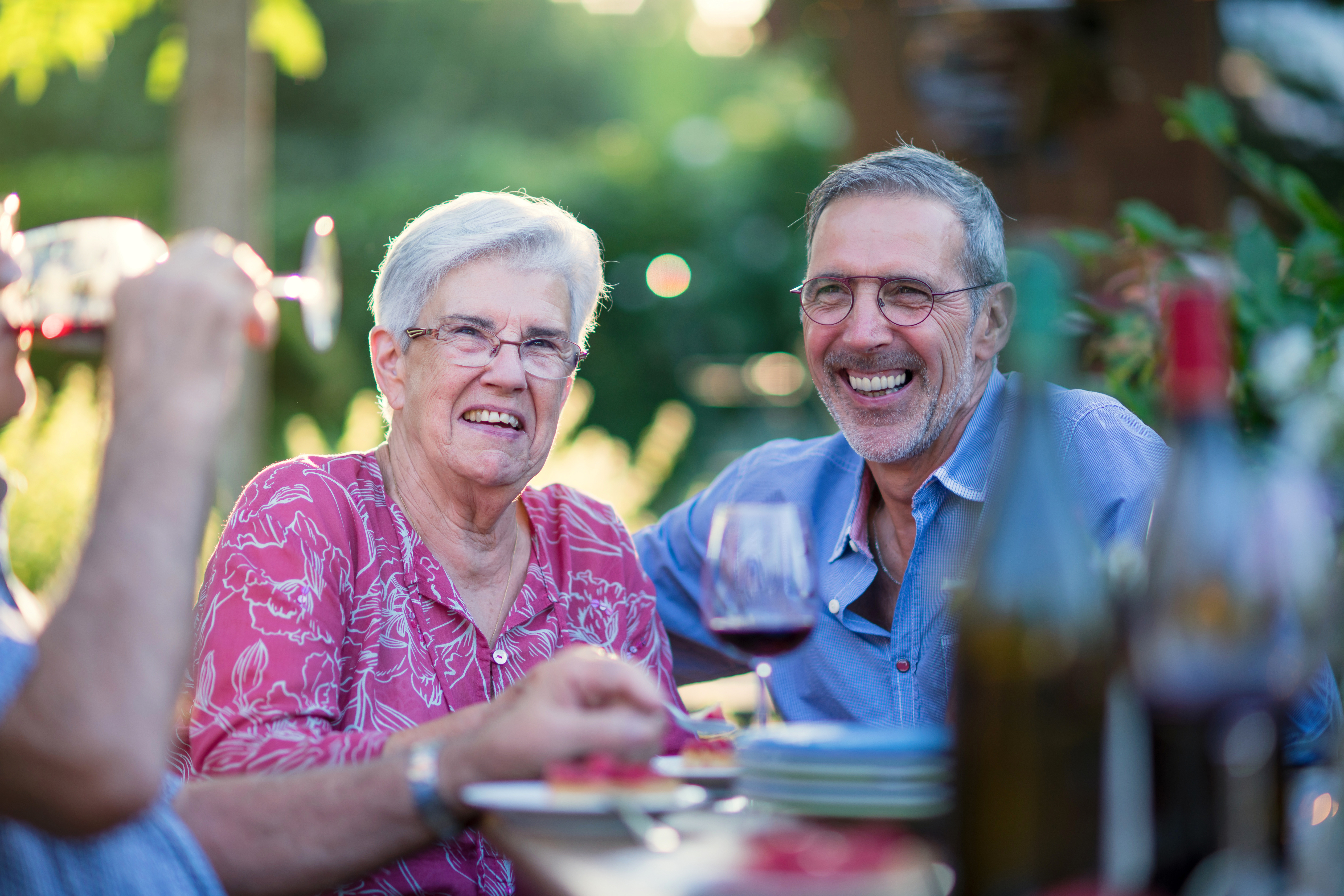 Mother and Son celebrating with food and wine in garden 
