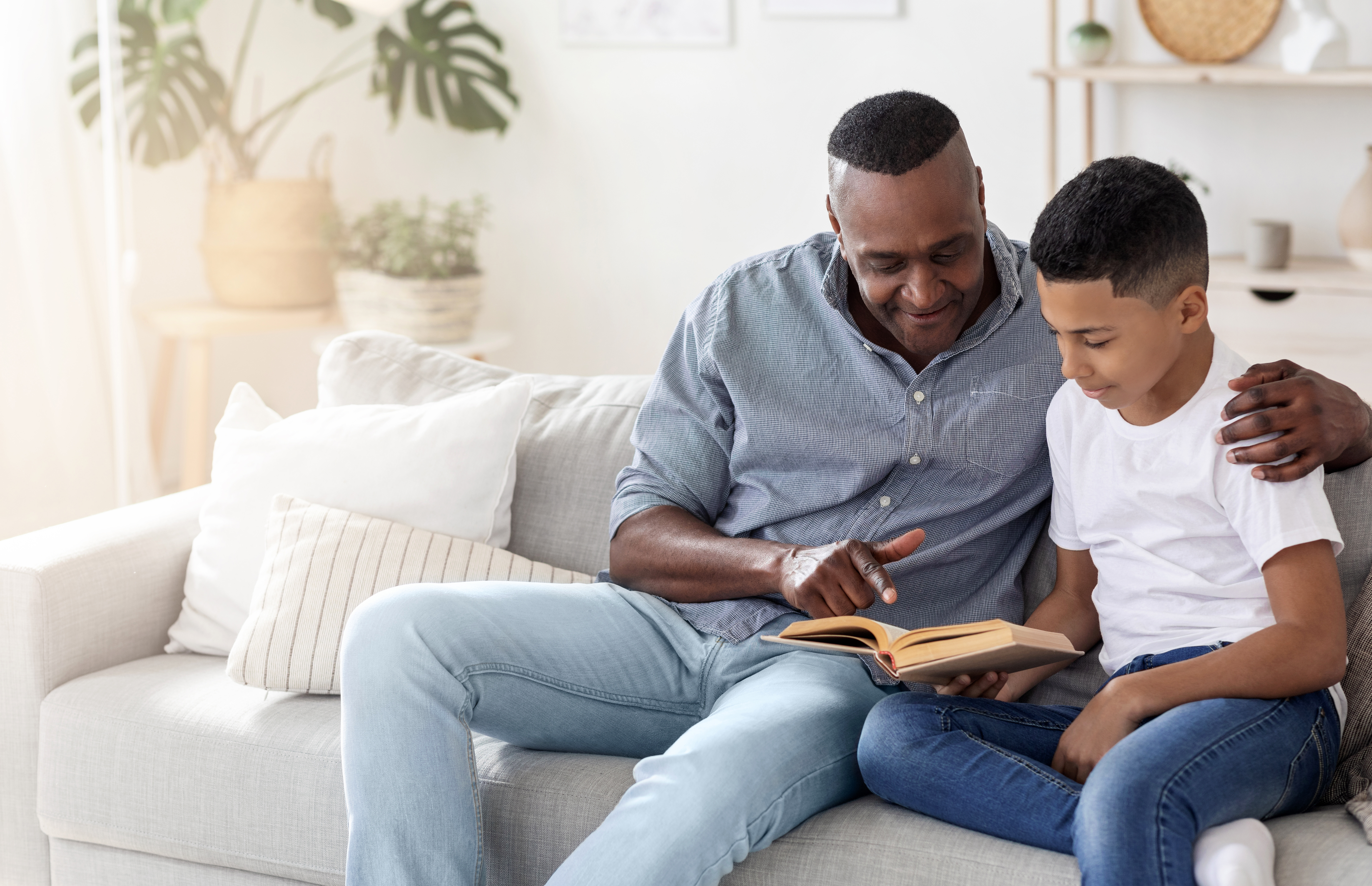 Man and boy reading together