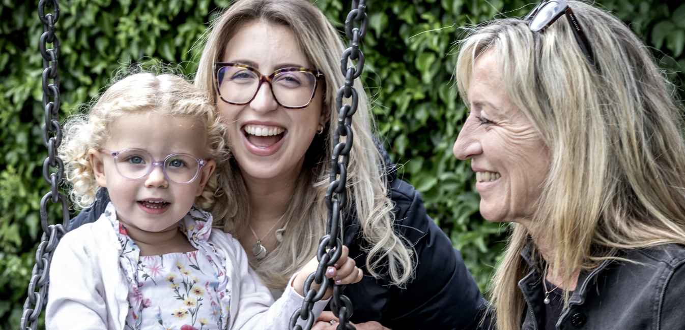 Gill and her daughter and granddaughter smiling and laughing together