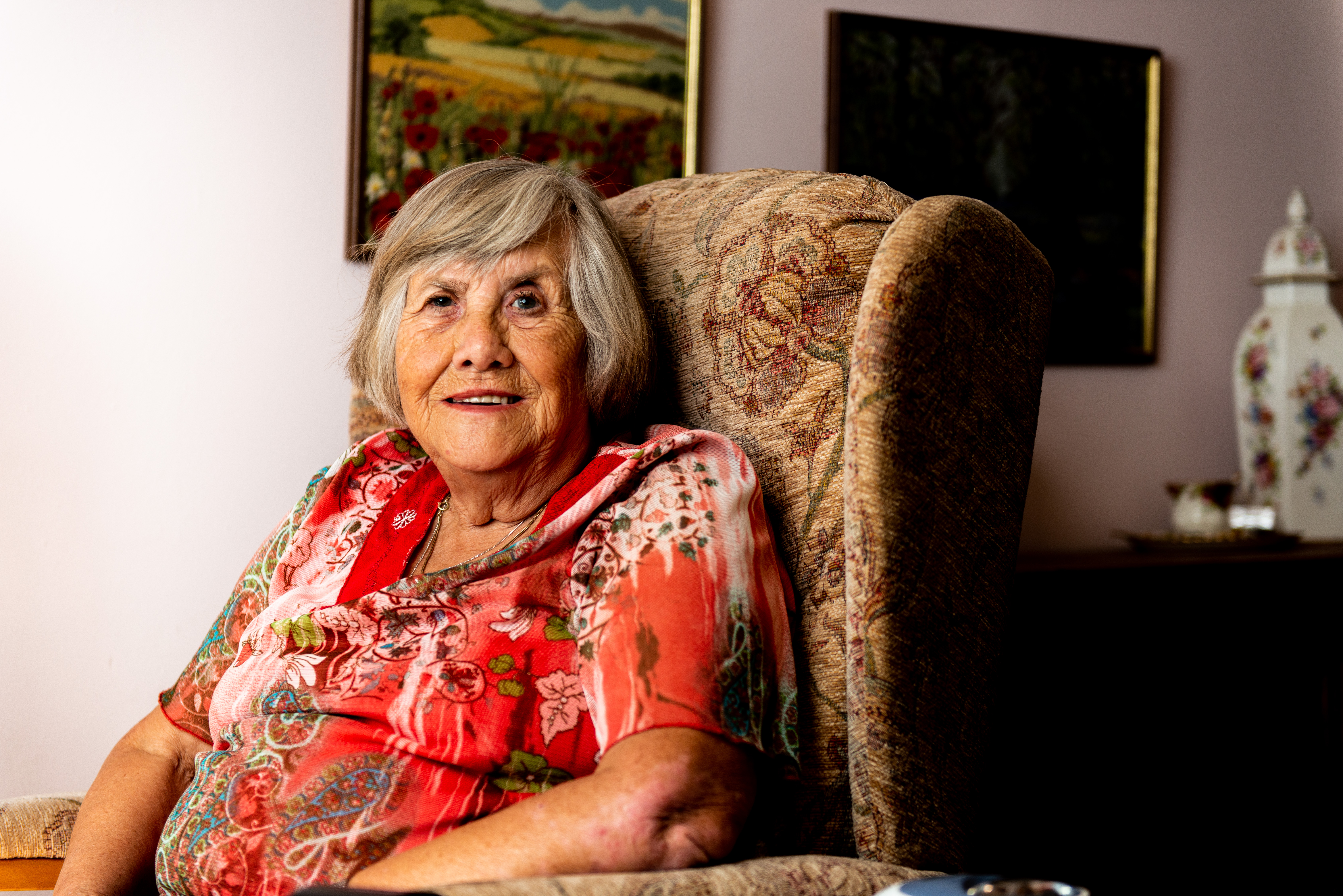 Pat Hayes smiling in armchair 
