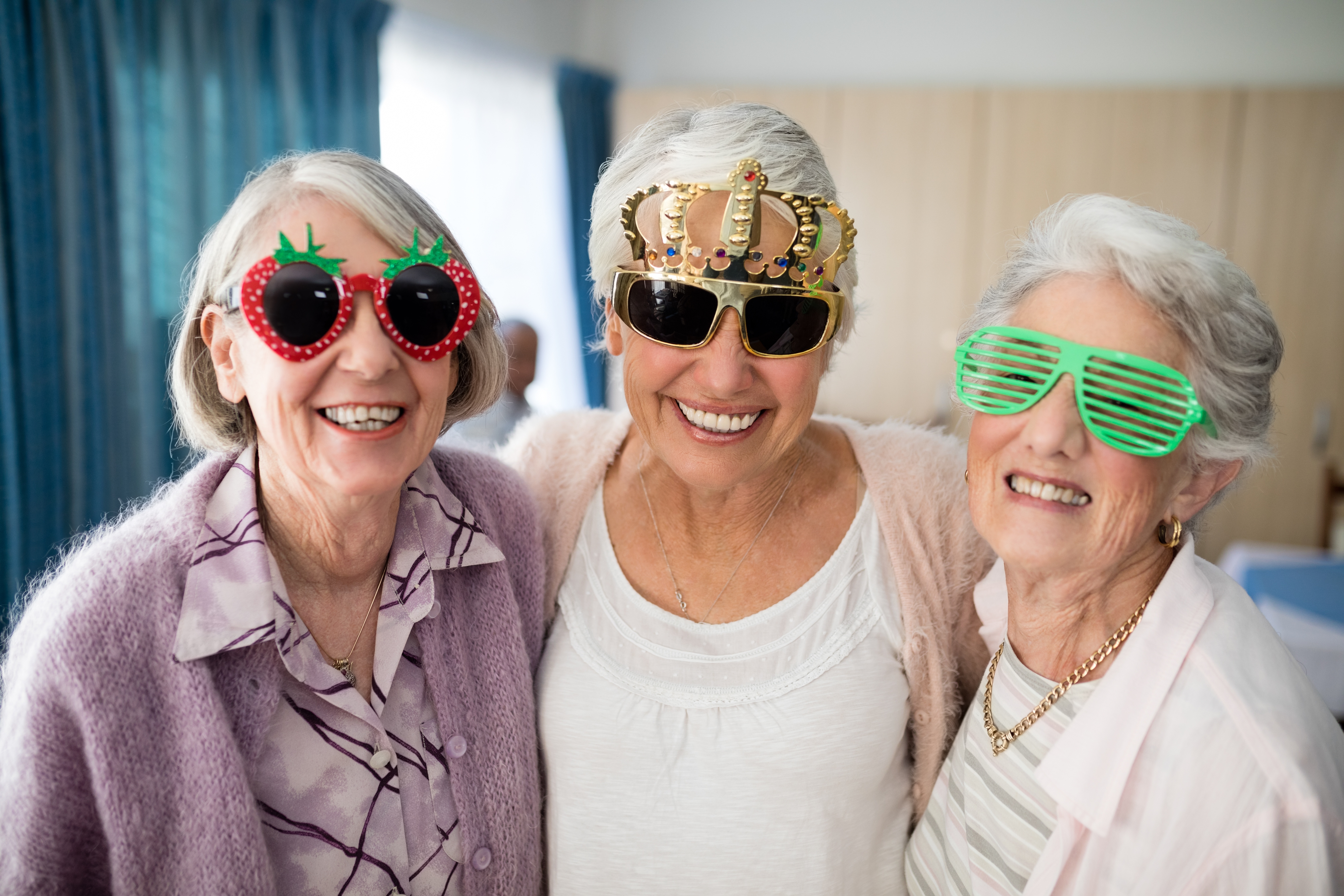 Three smiling ladies with fun sunglasses