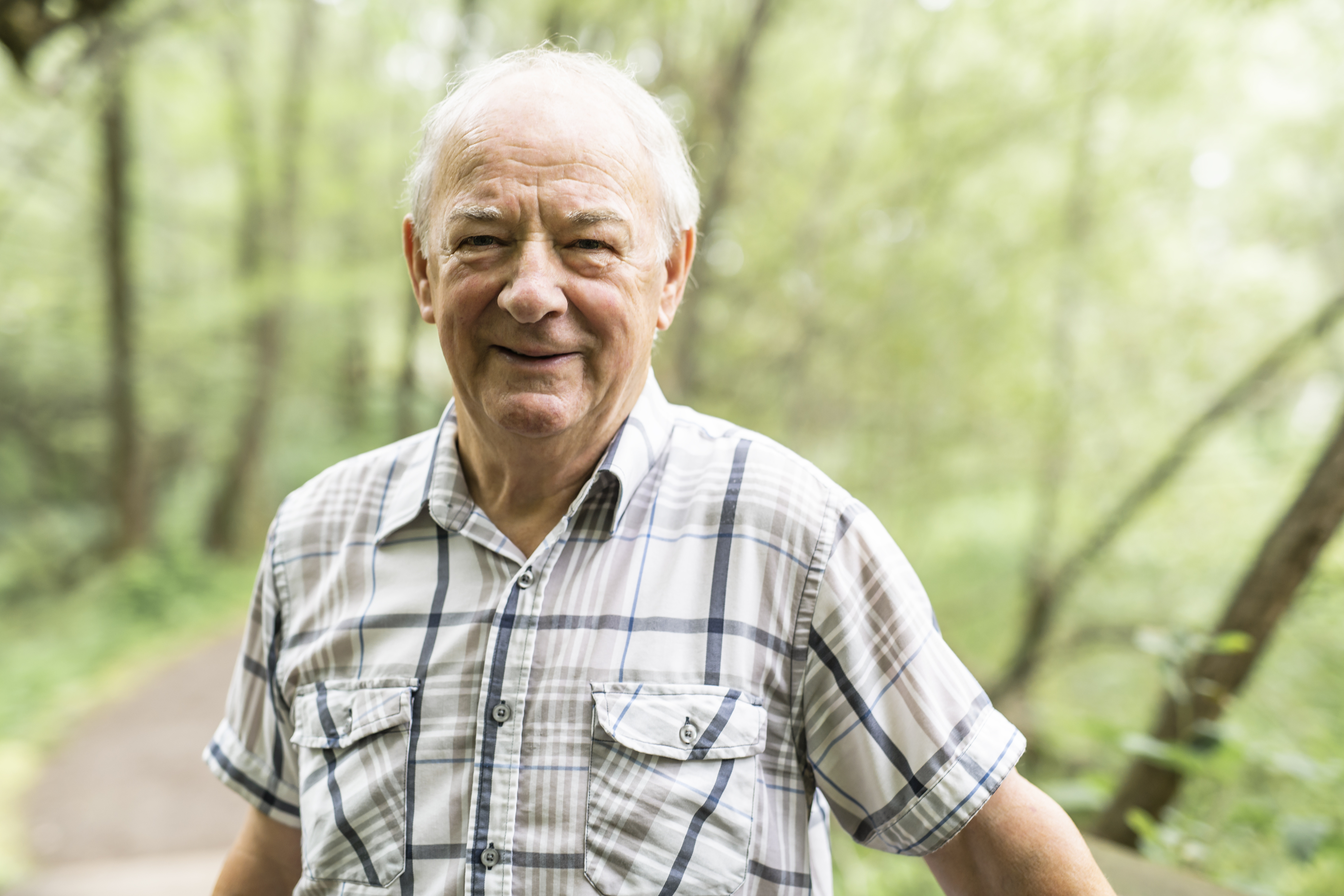 Elderly man smiling outside