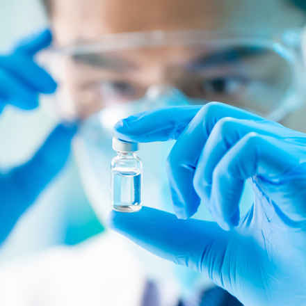 Scientist with drug vial