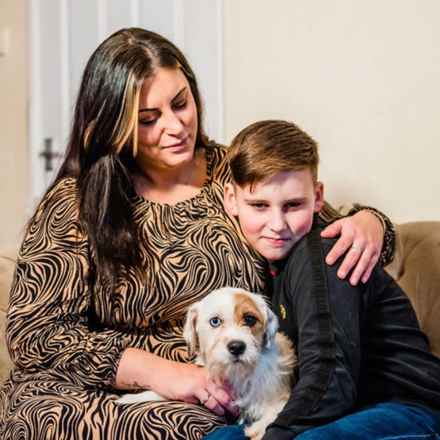 Stacy, son and dog sitting on sofa
