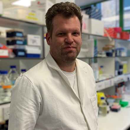 Gavin Arno in white laboratory coat